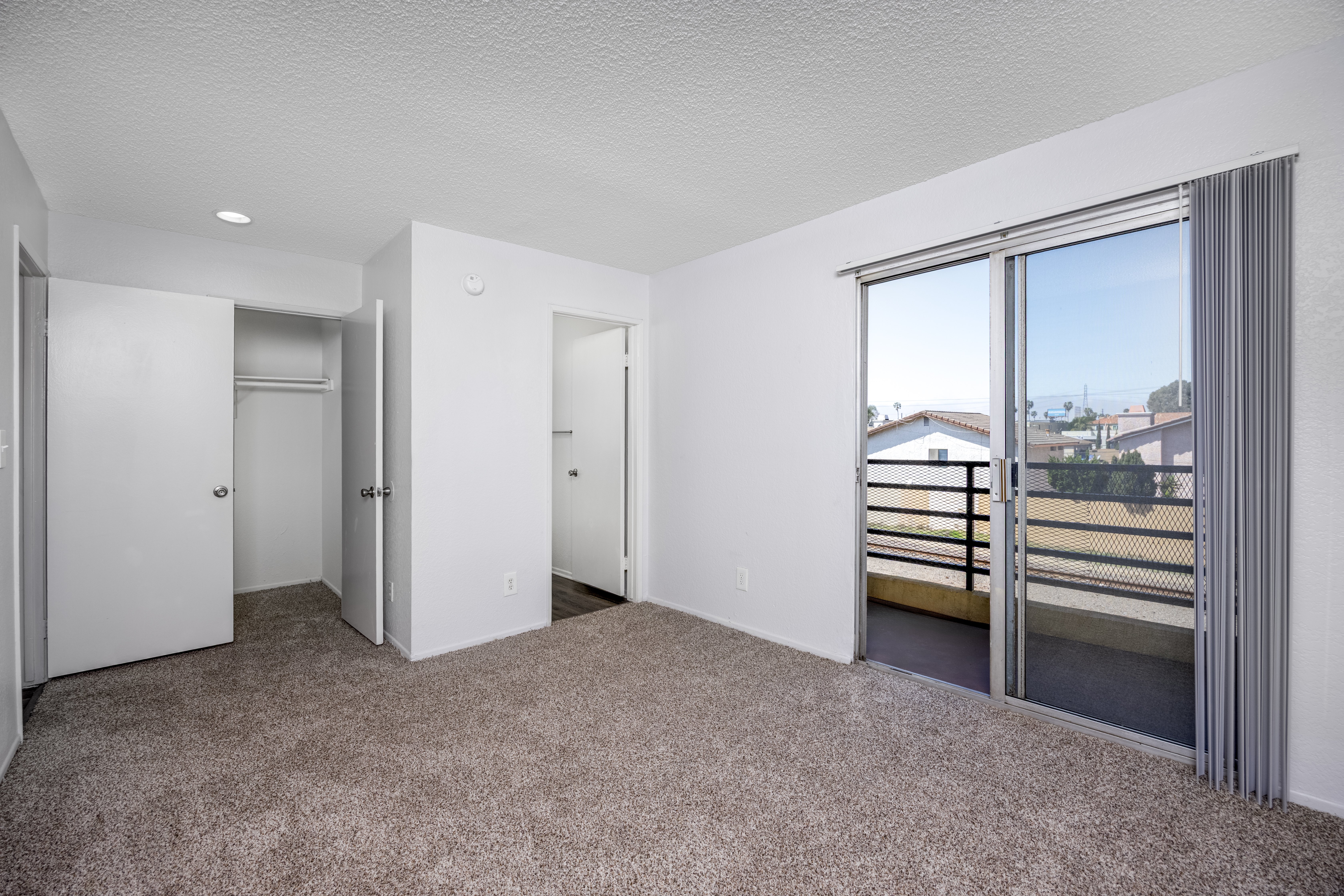 A spacious room with a view of the outside through a large window.